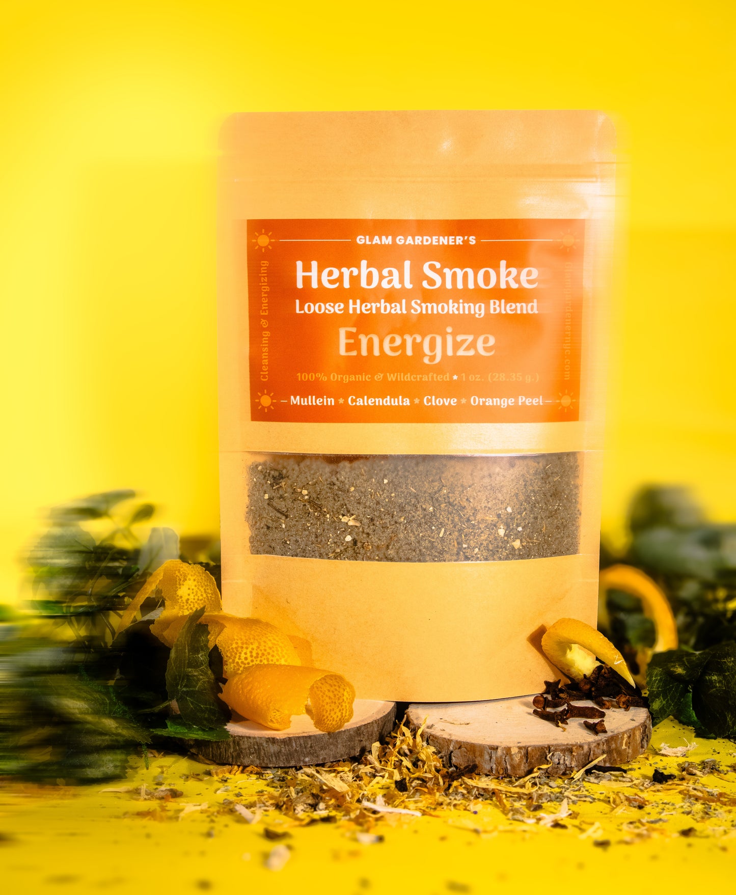 Glam Gardener NYC‘s loose herbal smoking blend called energize. It features mullein, calendula, clove, and orange peel. It’s 100% wildcrafted and organic. The background is yellow and there are orange spirals as a decorative element in the photoshoot.