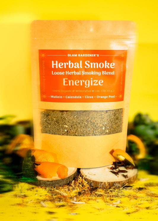 Glam Gardener NYC‘s loose herbal smoking blend called energize. It features mullein, calendula, clove, and orange peel. It’s 100% wildcrafted and organic. The background is yellow and there are orange spirals as a decorative element in the photoshoot.