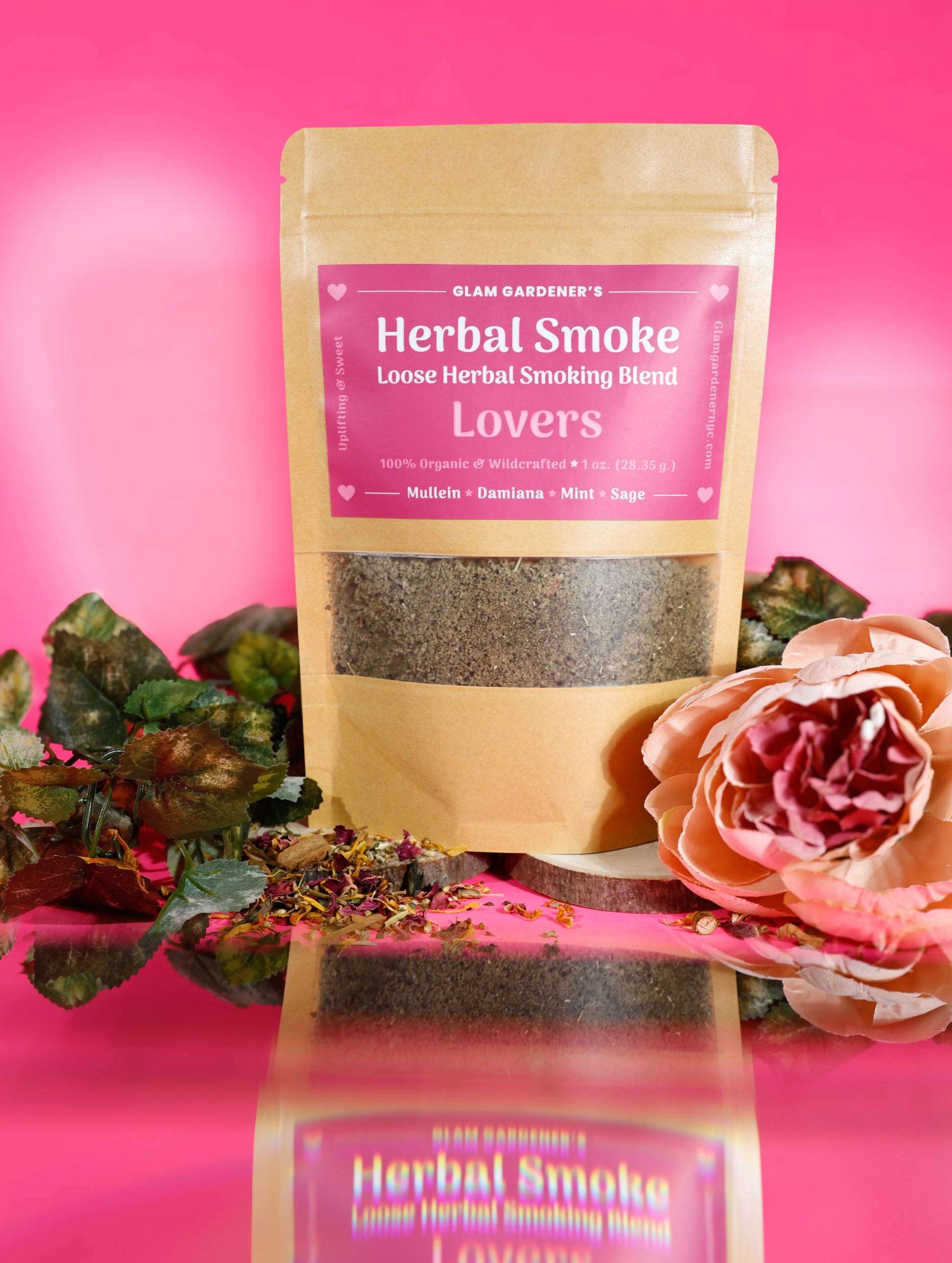 This image features, Glam Gardener NYC’s Lover’s herbal Smoking blended with Mullen, Damiana, mint, and sage. This photo features a pink background with a floral and botanical vibe to it. Glam Gardener NYC handcrafts herbal smoking blends and herbal teas.