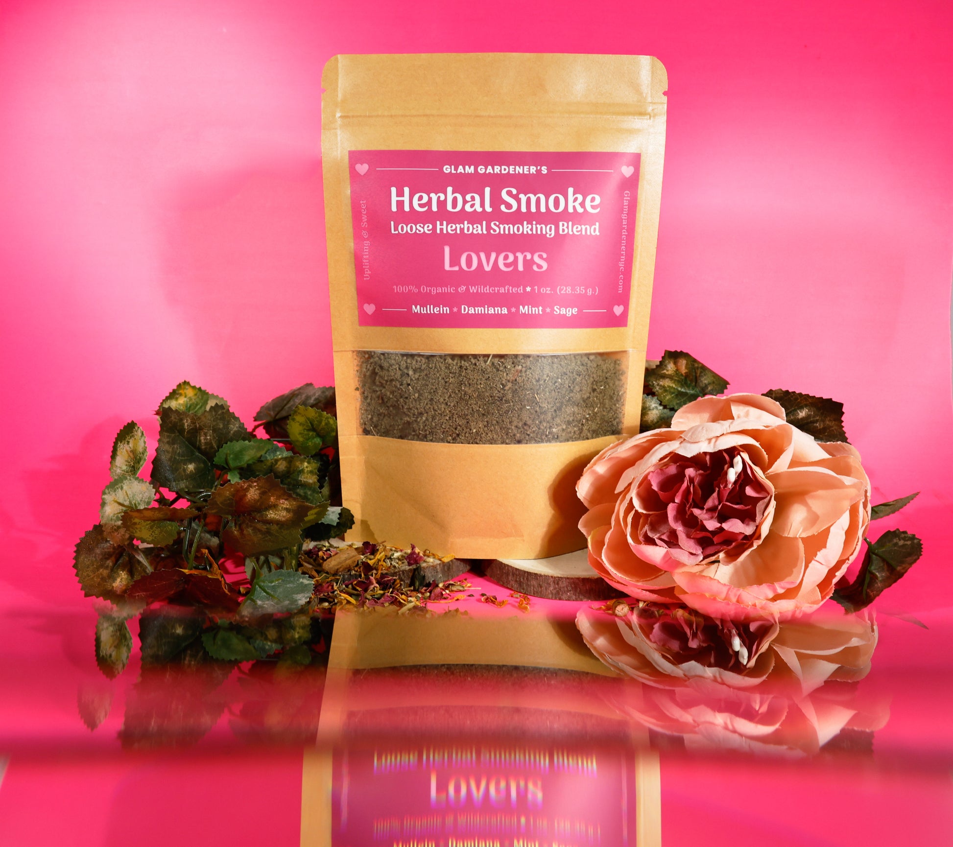 This image features, Glam Gardener NYC’s Lover’s herbal Smoking blended with Mullen, Damiana, mint, and sage. This photo features a pink background with a floral and botanical vibe to it. Glam Gardener NYC handcrafts herbal smoking blends and herbal teas.