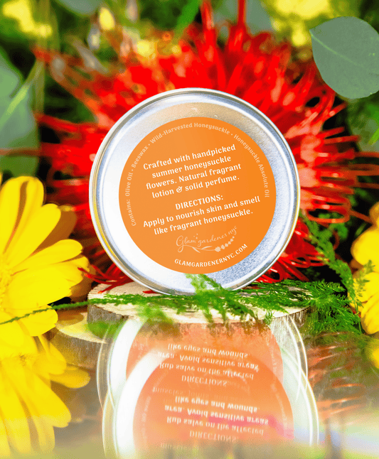 Back label of Glam Gardener’s lSweet Nectar' scented salve and all-natural fragrant lotion infused with authentic Honeysuckle absolute oil, with a blurred floral background. The salve is 2 ounces and all natural, handcrafted by Glam Gardener NYC. It reads the ingredients: Olive Oil, Beeswax, Honeysuckle, Honeysuckle absolute oil