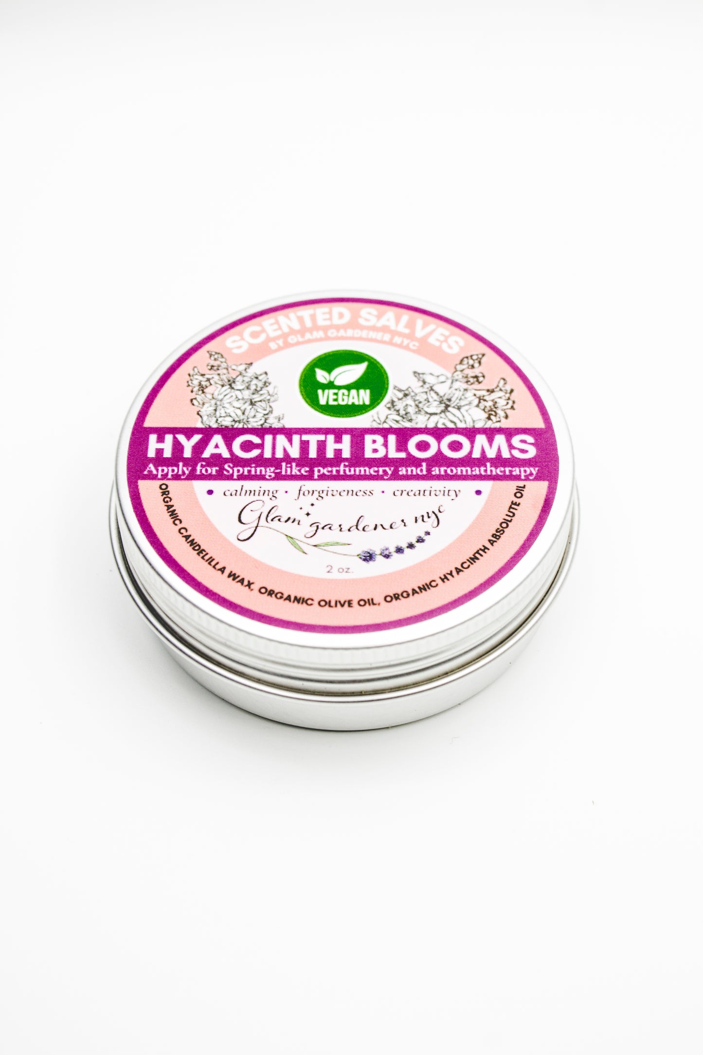 Tin of Glam Gardener's Vegan 'Hyacinth Blooms' salve with a pink label on a white background