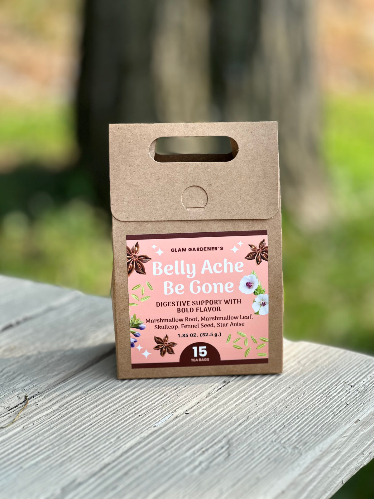 A kraft paper pouch of Islam Gardener's Belly Ache Be Gone digestive support stands on a weathered wooden surface with a blurred outdoor background. Across many cultures, fennel seed is consumed after meals to help the body digest. Skullcap is a plant native to America known to calm the body. Combined with Marshmallow, Belly Ache Be Gone works to soothe an irritable belly. These medicinal plants are also known for their unique flavors and anti-inflammatory properties.