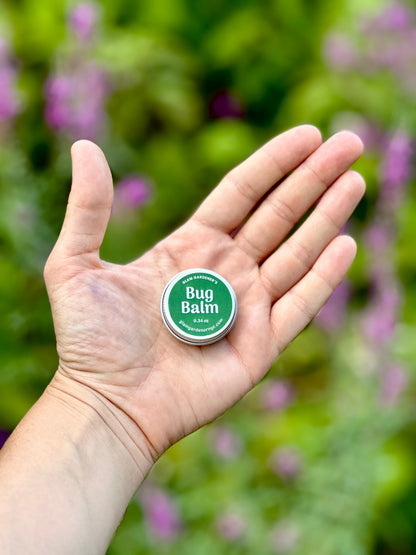 Hand holding small miniature bug repellent salve by Glam Gardener NYC