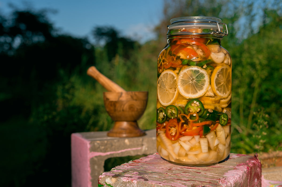 Fire Cider in Glass Jar with Natural Green Background by Glam Gardener