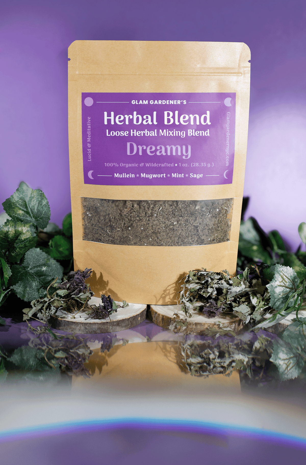 Glam Gardener's Pre-ground Herbal Mixing Blend with Mullein, Mugwort, Mint, and Sage. All ingredients are organic, wildcrafted, and pre-ground finely. The label is purple and reads "Glam Gardener's Herbl Blend Loose Herbal Mixing Blend Dreamy 100% Organic & Wildcrafted 1 oz 28.35 g) Mullein * Mugwort * Mint * Sage Lucid & Meditative Glamgardenernyc.com. The background is purple and the embellishments in the photo are floral with green ivy looking leaves. 