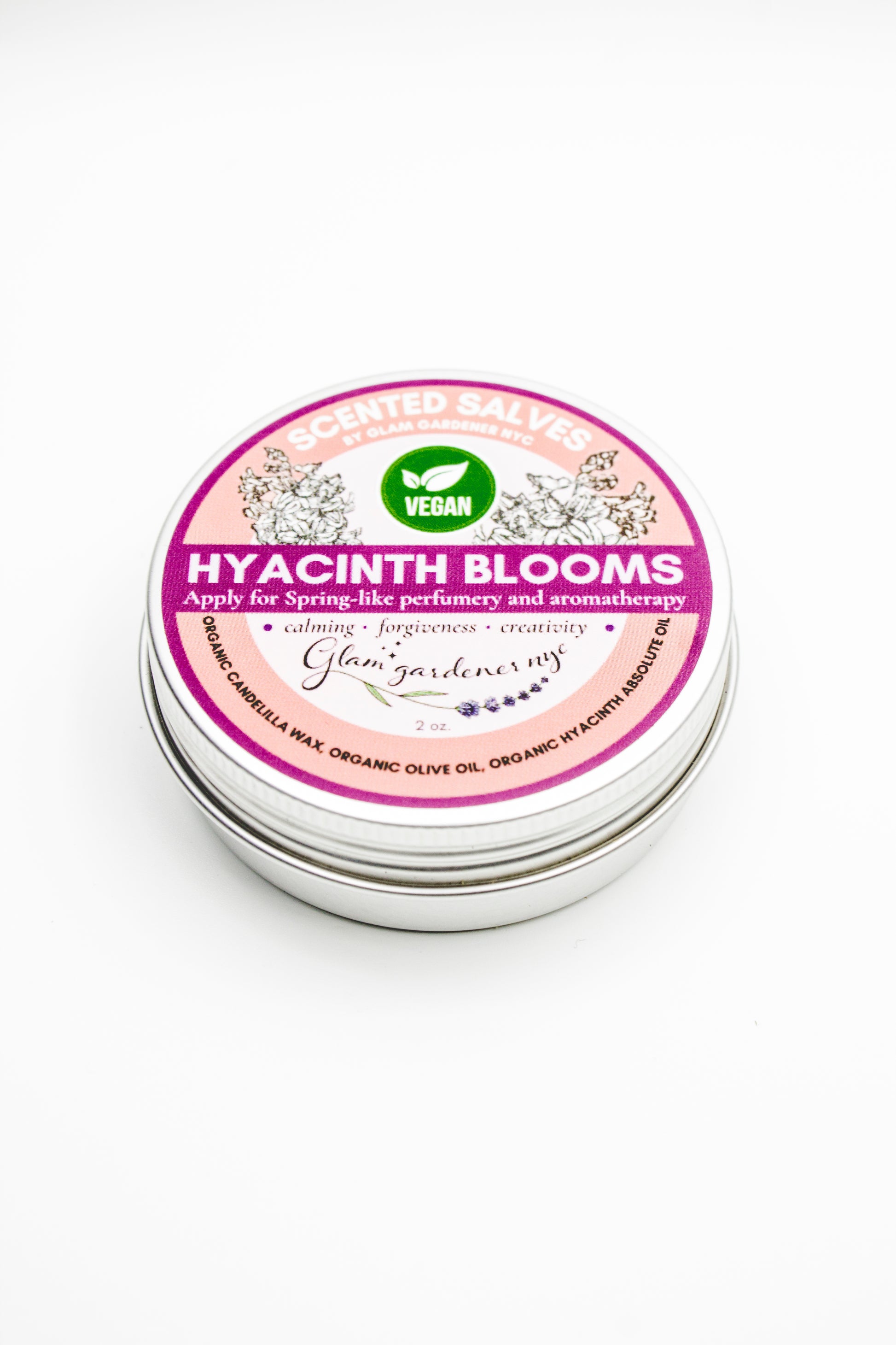 Tin of Glam Gardener's Vegan 'Hyacinth Blooms' salve with a pink label on a white background