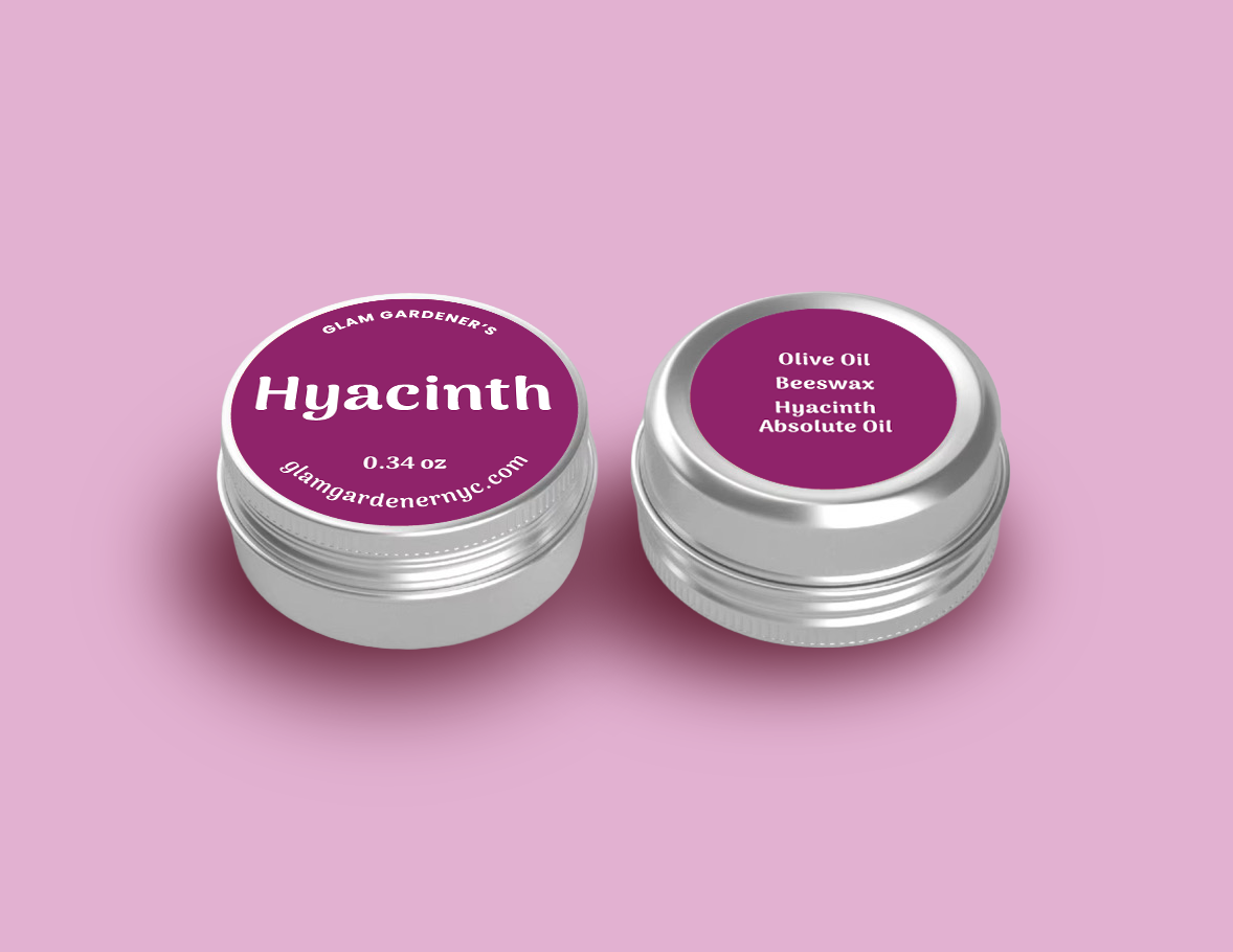 Glam Gardener NYC mini Hyacinth Blooms salve contains Olive Oil, beeswax, and hyacinth absolute oil. It is 0.34 ounces and is available at glamgardenernyc.com. It is all natural and has a pink label.